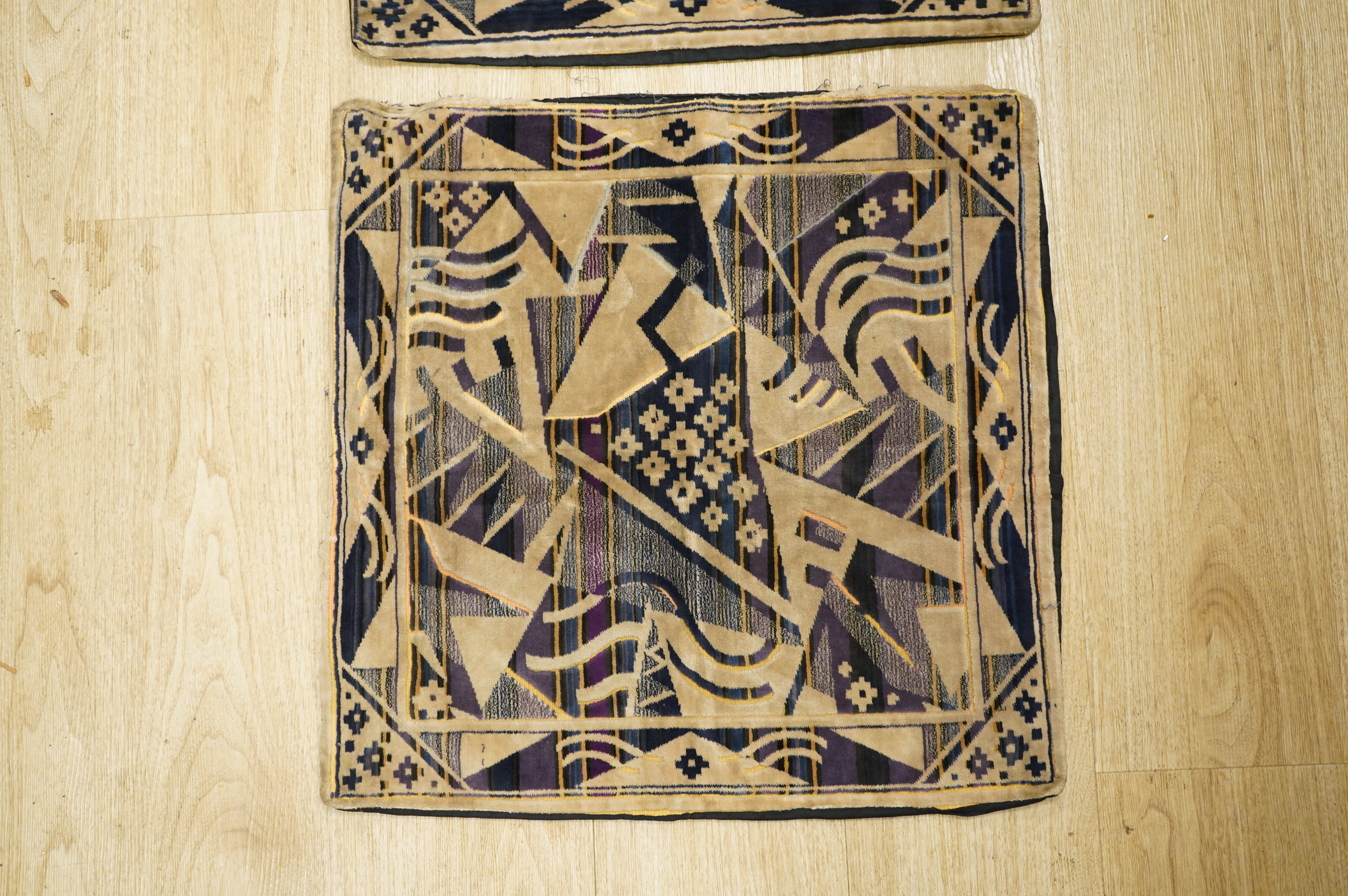 A collection of 20th century textiles to include: child's cream and gold embroidered waistcoat, a metallic embroidered bag, a leather embroidered bag, two Art Deco printed velvet cushion covers, a cotton quilted runner a